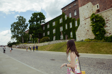 Beautiful girl during sightseeing old castle in Cracow, Wawel.