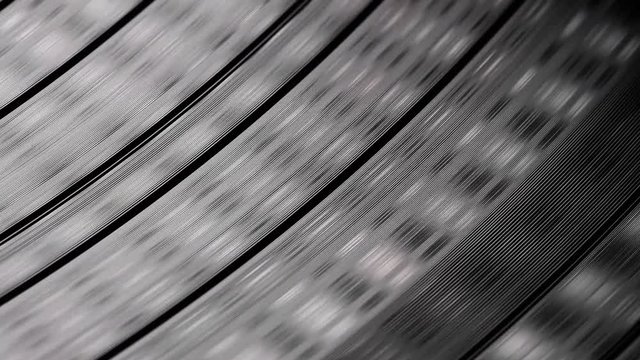 Abstract close up of vinyl disc spinning on turntable