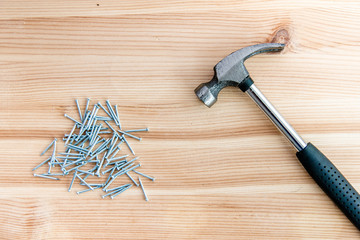 Hammer and nails on a wooden background © pom669