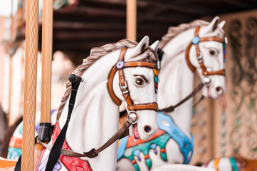 Fototapeta na wymiar Carousel at a carnival or festival. Decorative ornate horse at a fun fair.