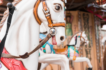 Fototapeta na wymiar Carousel at a carnival or festival. Decorative ornate horse at a fun fair.