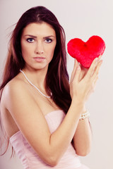 Beautiful woman holds red heart