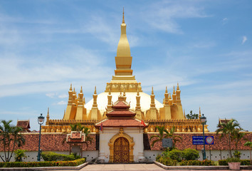 Fototapeta premium The golden pagoda wat Phra That Luang in Vientiane. Buddhist temple. Famous tourist destination in Asia. (Laos travel landmark)