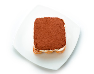 Tiramisu on white plate isolated. Clipping path. Top view.