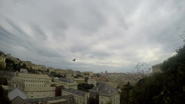 The grey clouds slowly floating over a large city. Urban tranquility. Grey houses stand alone as a house of cards. The frozen city. Journey through Europe. Italy Genoa