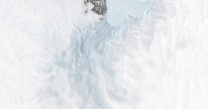 High-altitude overflight aerial of the rapidly receding Jakobshavn Glacier, Greenland. Clip loops and is reversible. Elements of this image furnished by USGS/NASA Landsat