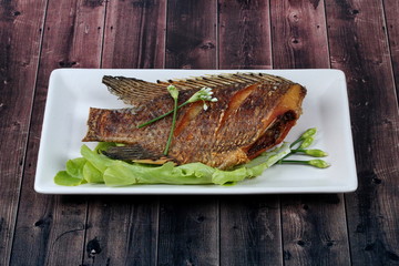 Deep fried little tilapia fish served with spicy bean sauce.