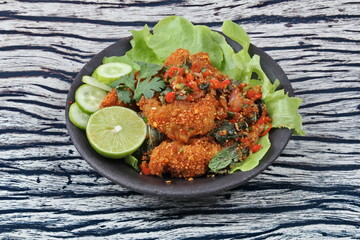 Spicy sour fried chicken salad call Yum Kai Zap - Thai.