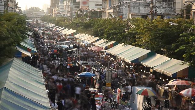 Crowd walking on street market at night in Bangkok, Thailand, time lapse