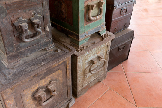 Old antique iron and wood travel chest in a stack used in the past with toned image as vintage background.