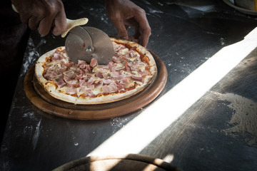 Hands preparing a pizza  (dark background)