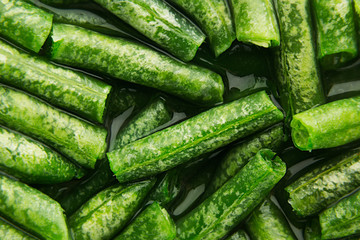 Wet fresh green french bean in water  closeup as background. Healthy vitamin food.