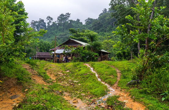 Vietnamese Farm Hut. Farm hut in a remote Vietnamese village. Small rain streams flowing down the paths in the front.