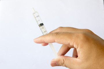 Man hold the plastic syringe on white background