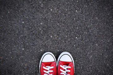 Red sneakers on road background .hipster tone and selective focus