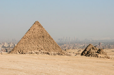 Pyramids with modern Cairo in the background.