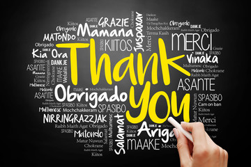 Hand writing Thank You Word Cloud in many languages on blackboard, presentation background