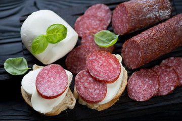 Close-up of italian bruschetta with salami and mozzarella cheese