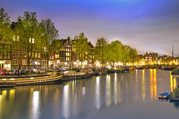 Fototapeta na wymiar Beautiful evening landscape on the canal in Amsterdam, Netherlan
