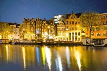 Fototapeta na wymiar Magic night view of the canal in Amsterdam, Holland, Europe with