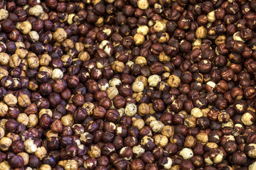 Pile of roasted hazelnuts for a background