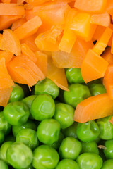 Green peas with chopped carrots flat lay background