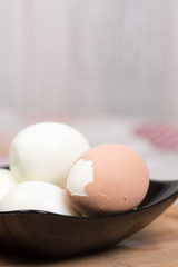 Boiled and pealed eggs served on the black plate