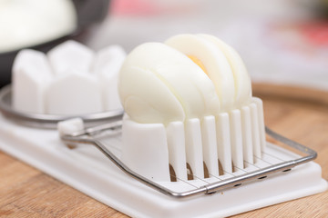 Fototapeta na wymiar Sliced boiled egg on the cutting machine