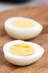Sliced boiled eggs on the wooden cutting board