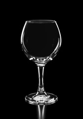 beautiful silhouette of empty wine glass isolated on black backg