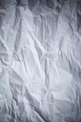 Recycled crumpled gray paper background dark edged.