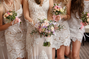 Wedding flowers, bride and bridesmaids holding their bouquets at wedding day. Happy wedding concept - Powered by Adobe