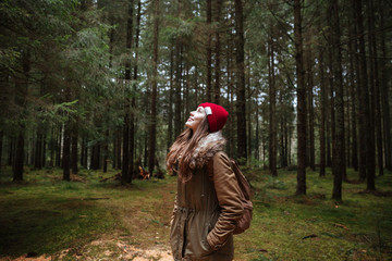 Pretty young woman standing in the forest