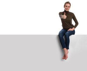 young woman sits on a blank placard