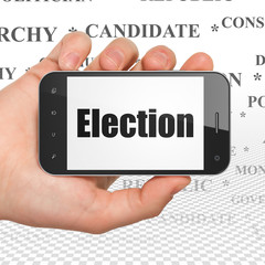 Political concept: Hand Holding Smartphone with Election on display