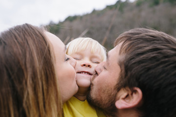 Fototapeta premium happy young family outdoor. mother, father and little daughter enjoying life