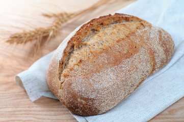 fresh loaf of bread on  wooden background, closeup view