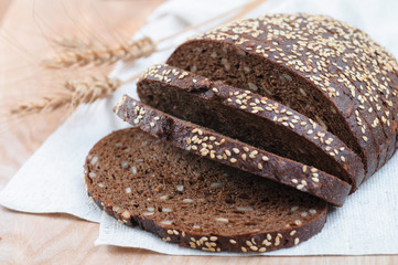 fresh rye bread with sunflower seeds on wooden background, cutou