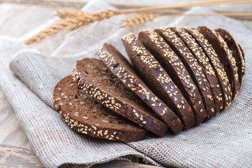 Traditional black rye bread with seeds on vintage table