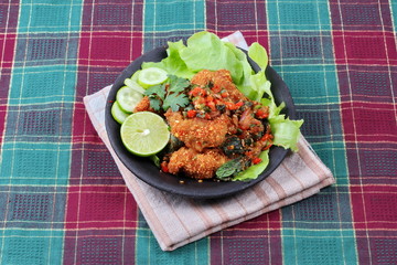 Spicy sour fried chicken salad call Yum Kai Zap - Thai.