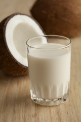 Coconut with s glass of coconut milk