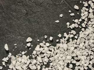 coarse sea salt on dark background close up