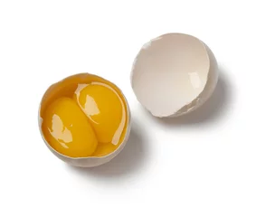 Zelfklevend Fotobehang  Broken double yolk egg in the shell © Picture Partners