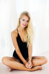 portrait of a beautiful blonde woman on beach with blue eyes