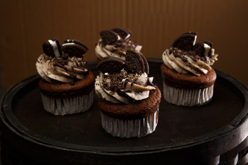 Delicious Oreo cupcakes on dark background. selective focus