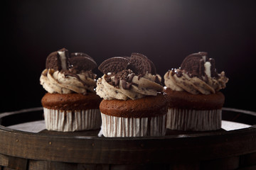 Delicious Oreo cupcakes on dark background. selective focus