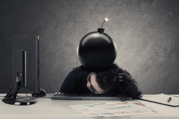 Entrepreneur sleeps on desk with bomb