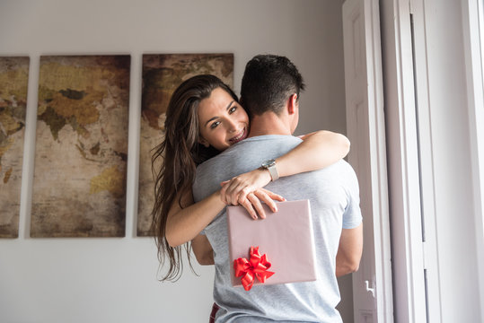 happy young couple in love surprising each other with gifts