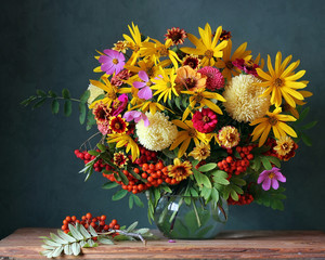 Autumn bouquet with garden flowers and berries.