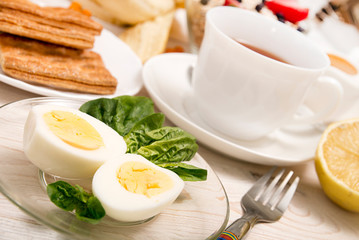 Healthy organic breakfast. Boiled eggs, cup of tea, cookies